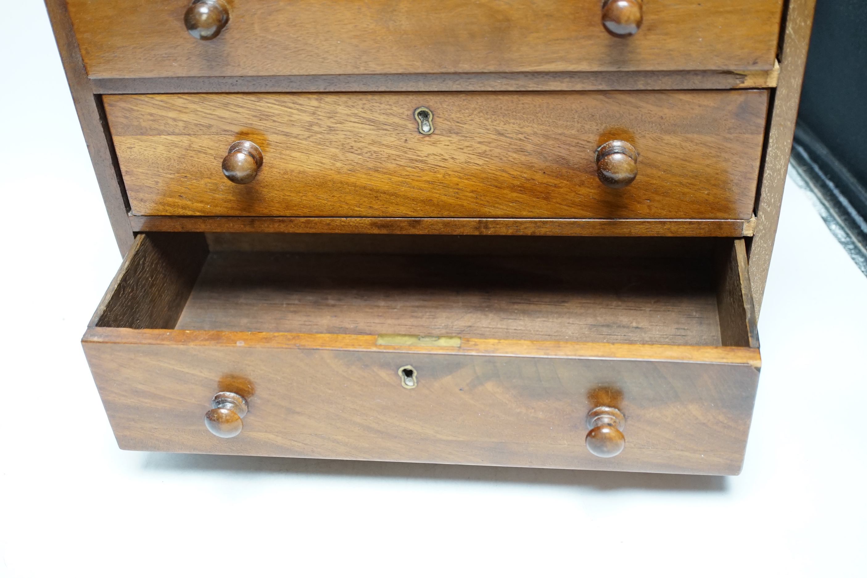 A Victorian mahogany miniature four draw chest, an amboyna glove box and a games box